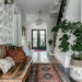 Eclectic home style entryway with layered rugs, patterned tile, wallpaper, and a mix of textures—save this for pattern mixing home decor inspiration.