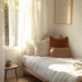 Cozy tiny bedroom idea with layered neutral bedding, soft lighting, and a calming vibe – Pin this for warm small space inspiration!